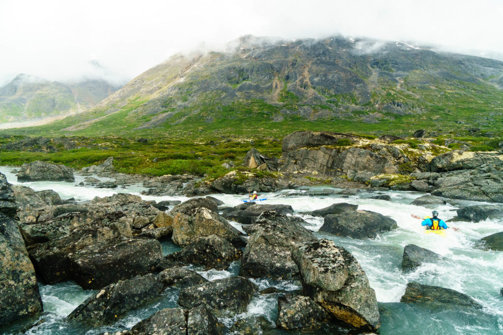 A typical day one scene -- fun class III boogie and a unique alpine riverbed surrounded by mountains.